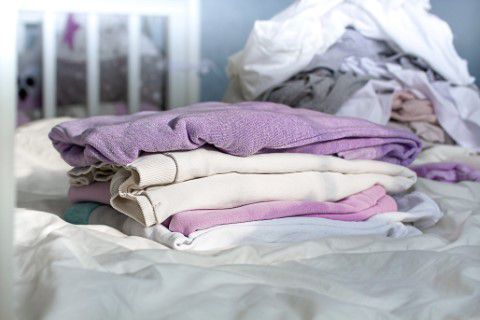 Pile of clothes on a bed for a charity