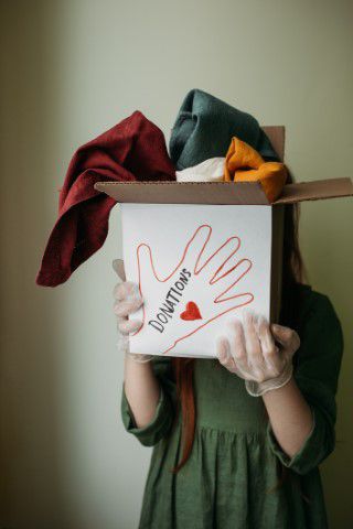 Woman holding a box of clothes to donate